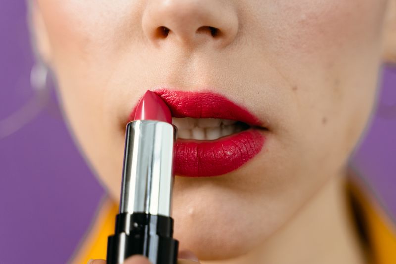 Applying vibrant lipstick