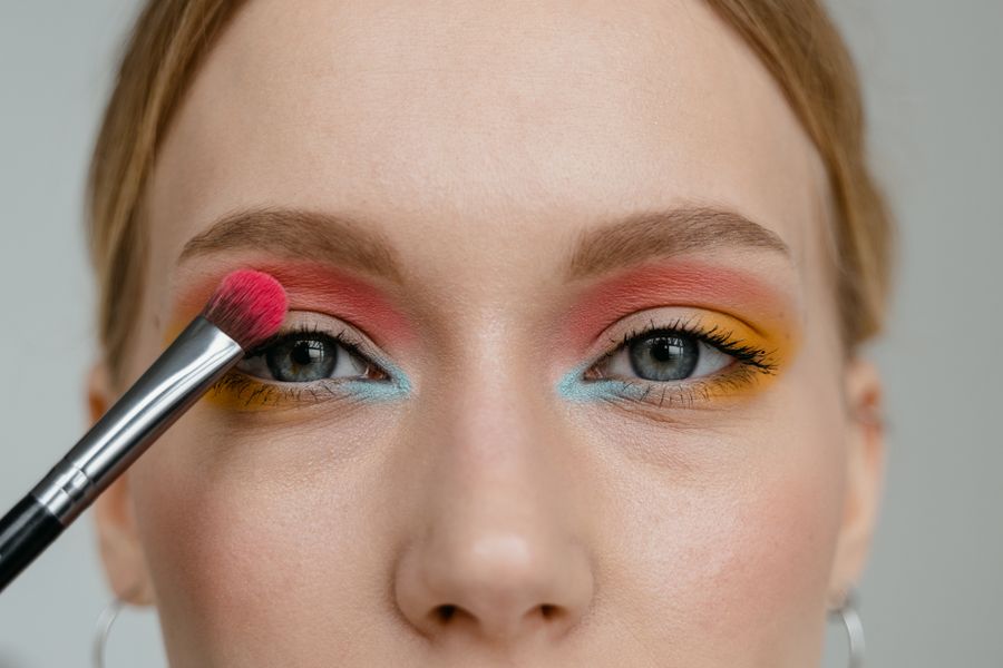 Applying colourful eyeshadow with a brush